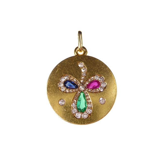 Antique gold and coloured gem set clover pendant, the circular gold panel inset with a three leaf clover formed of a pear shaped facetted emerald, sapphire and ruby, | MasterArt